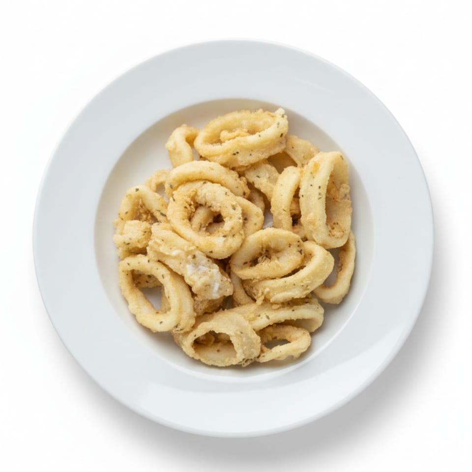 A white plate filled with golden-brown fried calamari rings, seasoned with herbs.