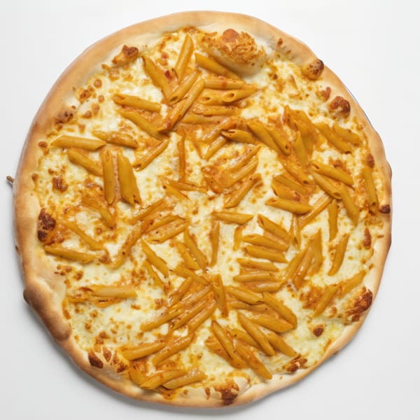 Cafe Amici's penne pasta pizza, topped with melted cheese and penne pasta in sauce.